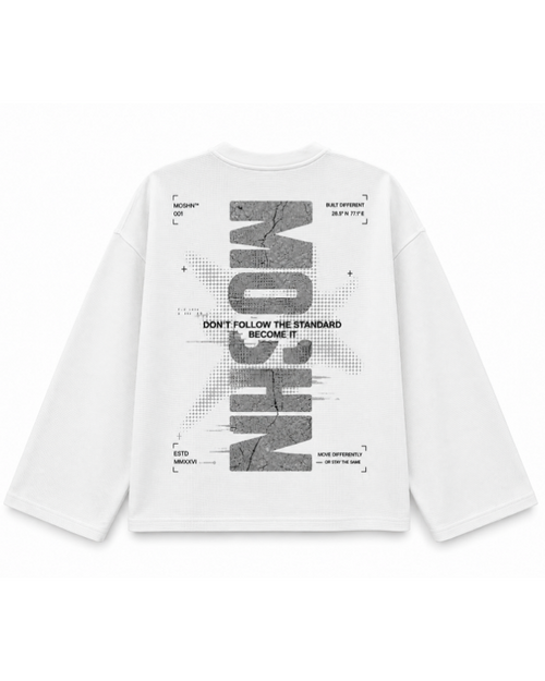 A white long-sleeve t-shirt with a large, stylized graphic print on the back. The graphic features the word 'NICHOM' in a cracked, textured gray font, surrounded by small black text elements and a subtle diagonal line pattern.